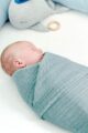Baby eingewickelt in dunkelgrüner Babydecke Musselin aus OEKO Tex Baumwolle - Grünes funktionelles 4-in-1 Spucktuch, Stilltuch, Spieldecke & hochwertiges saugfähiges Pucktuch von Nordic Coast Company - Babyphoto